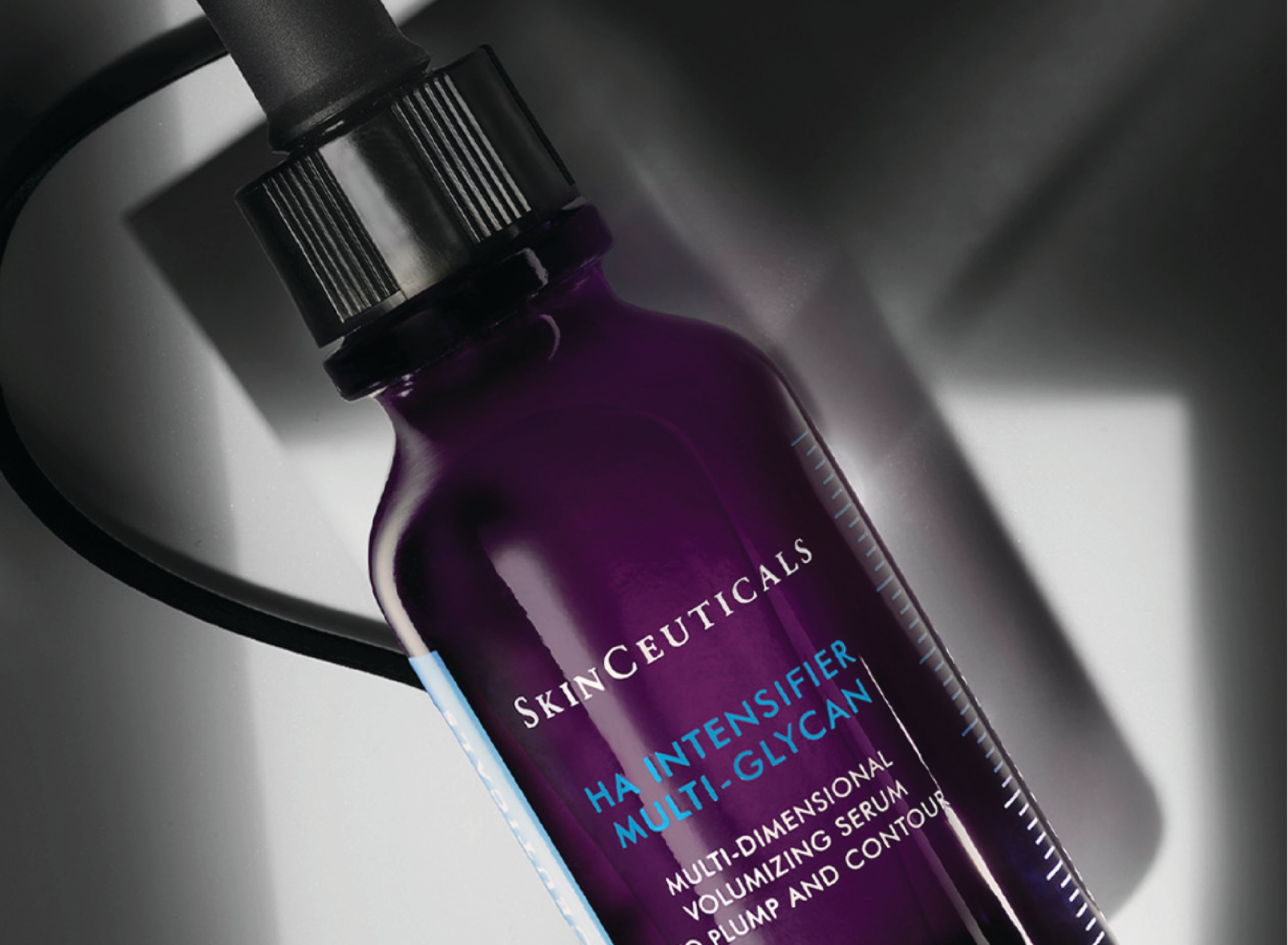 Close up of SkinCeuticals HA Intensifier Multi-Glycan on a black and grey background