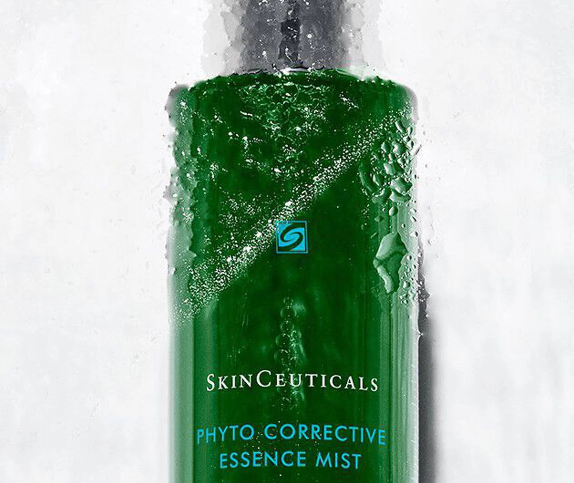 Green bottle of SkinCeuticals Phyto Corrective Essence Mist on a white background