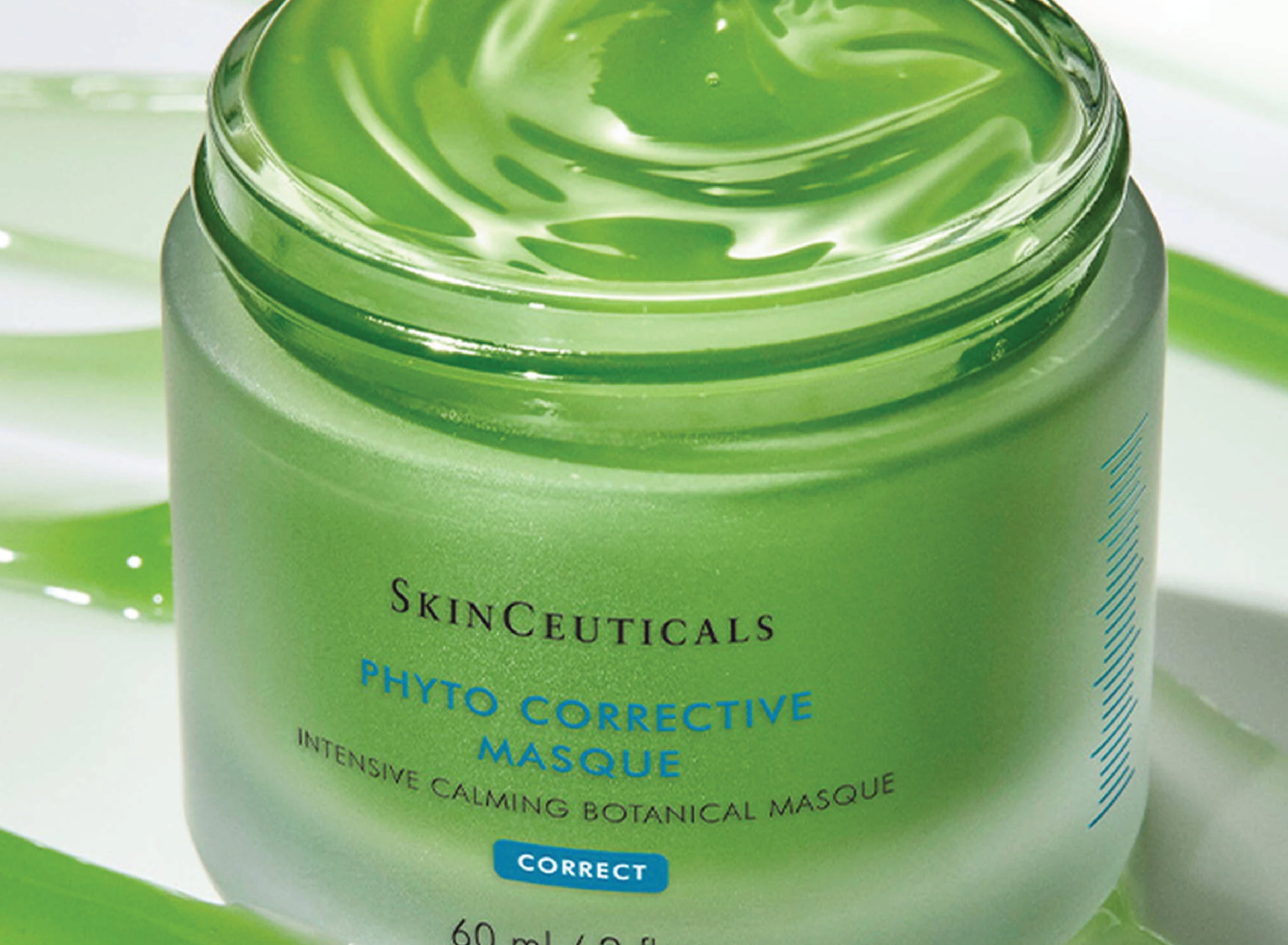 Phyto Corrective Masque with a green swirl background