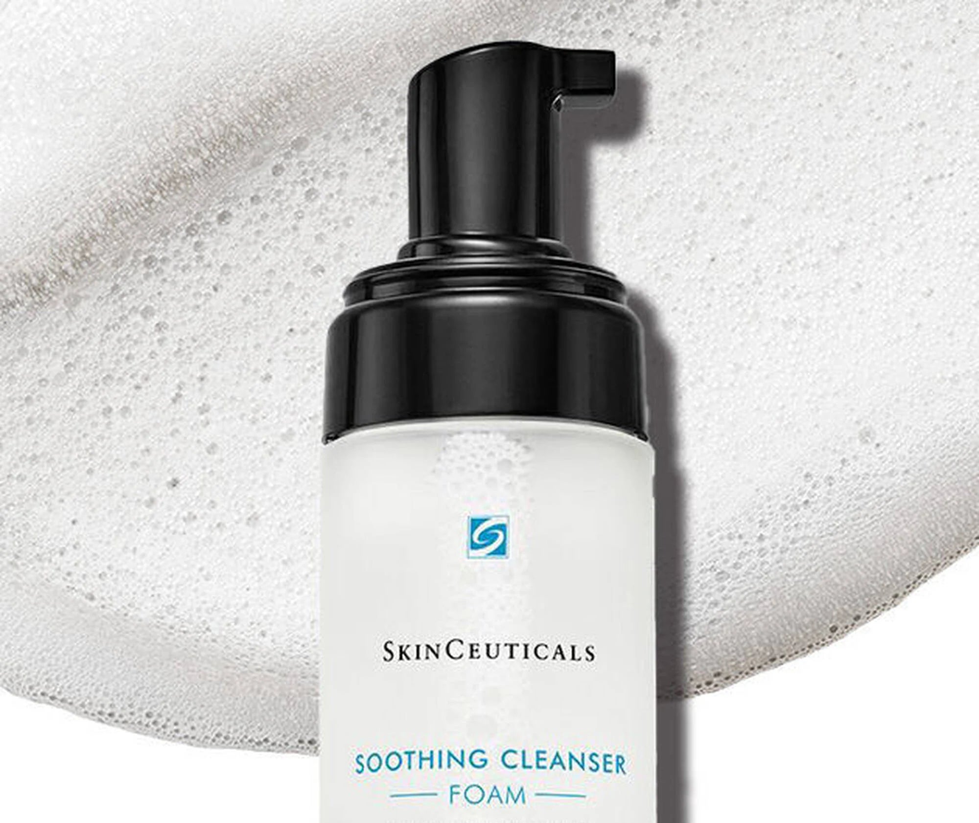 SkinCeuticals Soothing Cleanser Foam bottle with black pump on a textured gray background