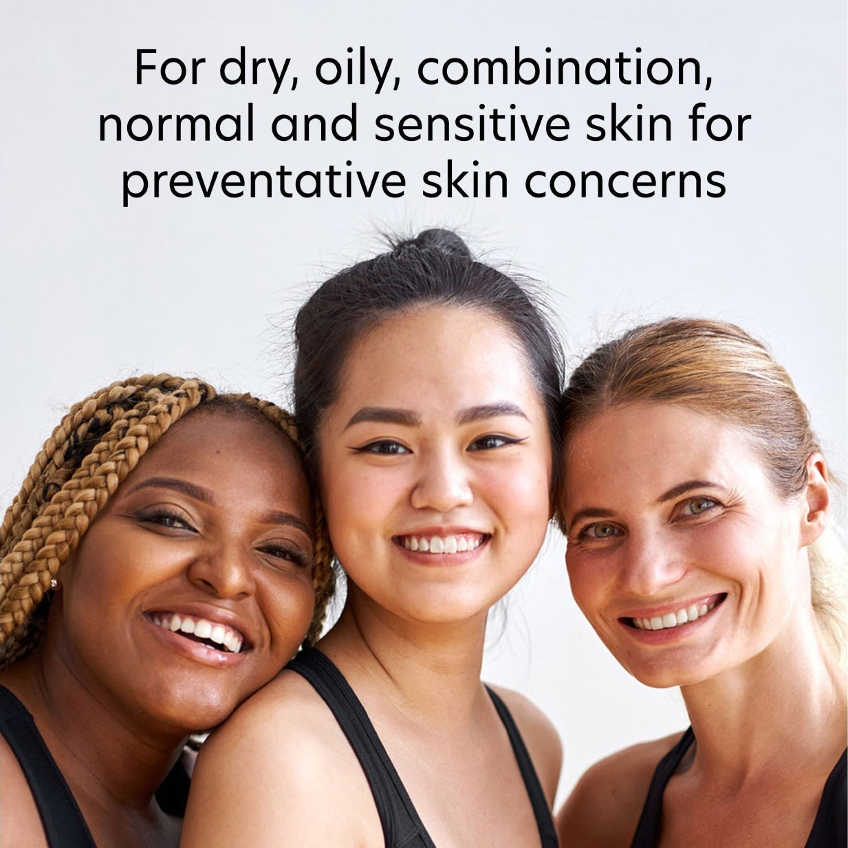 Three women with different skin tones smiling together, with text about skin care.
